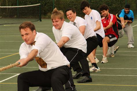 Teams pull on opposite ends of a rope, with the goal being to bring the rope a certain distance in one direction against the force of the opposing. Students take on staff in tug of war | The King's Academy