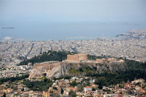 The View Of The Acropolis And Piraeus In The Distance From The Summit
