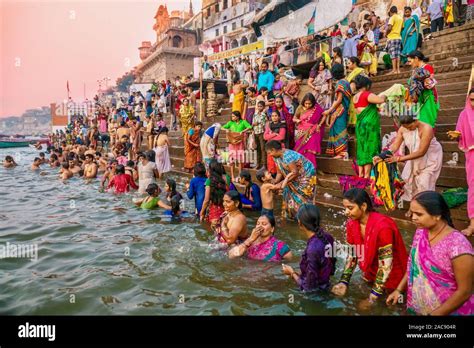 colorful traditional clothing and hindu religious ritual of bathing in the ganges river from the