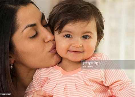 Mother Kissing Baby High Res Stock Photo Getty Images