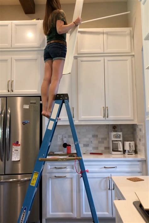 First, select a crown molding with a vertical height about the same as the narrowest gap between ceiling and cabinet. DIY Stacked Kitchen Cabinets - Frills and Drills