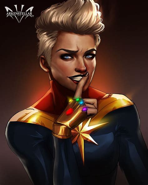 A Woman Dressed As Captain Marvel With Her Finger On Her Lips And