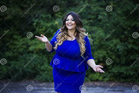 Young Happy Smiling Beautiful Plus Size Model In Blue Dress Outdoors