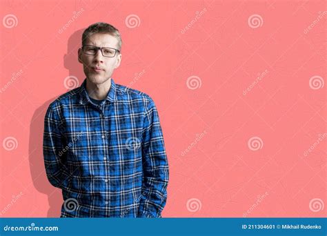 A Male Person In Checkered Shirt Isolated Near The Wall In Eyeglasses And Doing Eye Sight Check
