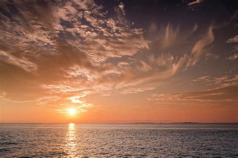 Beautiful Sunset Over The Ocean Waters Photograph By Ricardoreitmeyer