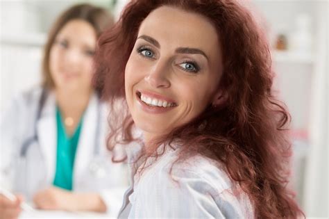 premium photo smiling happy female patient sitting at medicine doctor office medical service