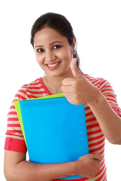 Female Student Holding Text Book With Thumb Up Gesture Stock Image