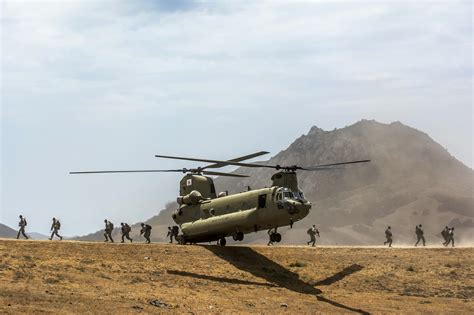 Army Reservist Off Load From A Ch 47 Chinook Helicopter Conducting An Air Assault Landing During