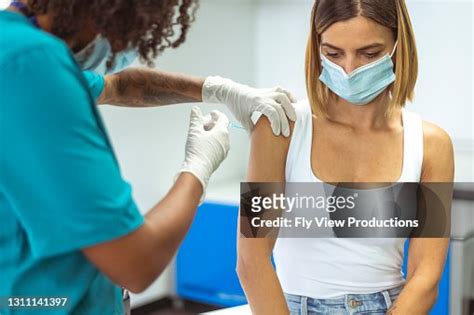 Mixed Race Nurse Injects Patient With Covid19 Vaccine High Res Stock