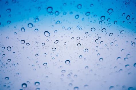 Blue Water Droplets And Raindrops Cling To The Cool Clear Glass Stock