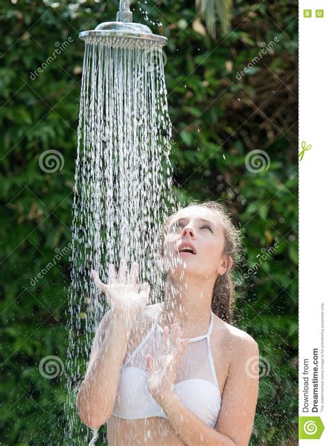 Girl Wear Bikini Standing Under The Outdoor Pool Shower Stock Image