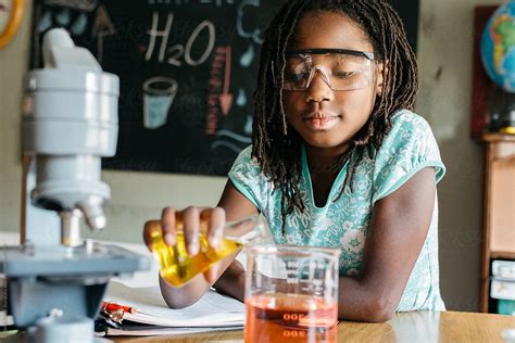 Black Girl Doing A Chemistry Experiment In Science Class By Stocksy