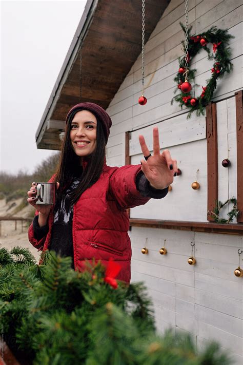Smiling Woman Showing Two Fingers Del Colaborador De Stocksy Danil Nevsky Stocksy