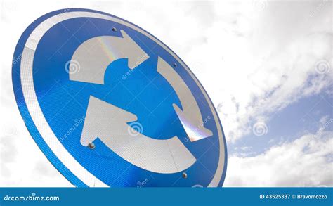 Blue Road Sign With Arrows In A Circle Against Sky Stock Image Image