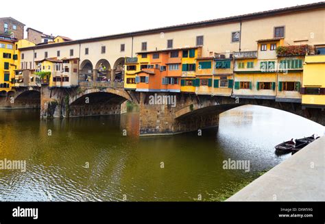 Colorful Shops On The Ponte Vecchio Bridge Spanning The Arno River In