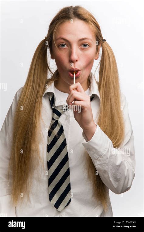 A Teenage Babegirl Wearing Babe Uniform Sucking A Lollypop With Her Blonde Hair In Bunches