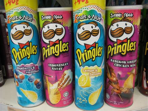 Three Cans Of Pringles Are Sitting On A Shelf In A Store One Is Blue