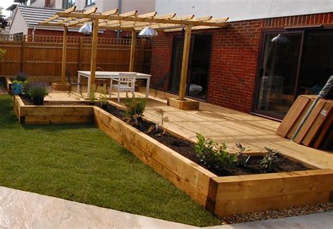 These decking ideas can be used in gardens of all shapes and sizes and will take you through the seasons, so that you can make the most of your deck all summer long and well into autumn. New Oxford railway sleeper patio & raised beds