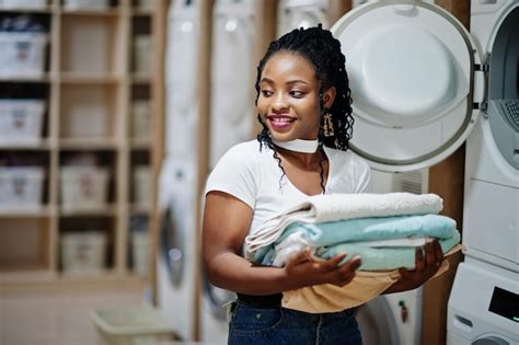 Premium Photo Cheerful African American Woman With Towels In Hands