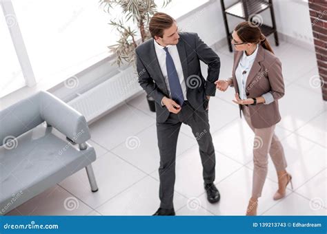 Manager Talking To An Employee In The Office Lobby Stock Image Image