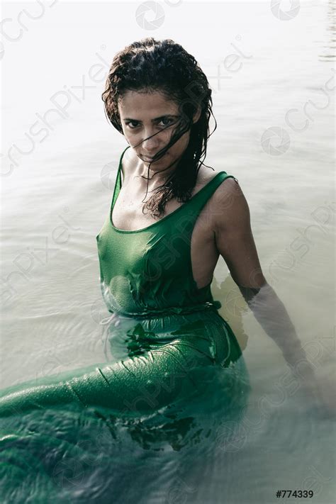 Beautiful Sultry Woman In A Wet Clinging Dress Stock Photo
