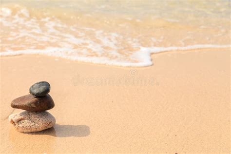Pyramid Of The Stones On The Sandy Beach At Ocean Background Stock