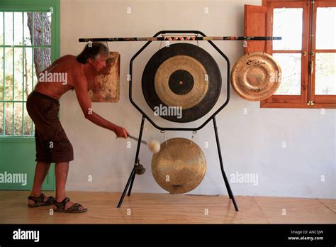 Man Playing Traditional Buddhist Gongs On Stand Stock Photo Alamy