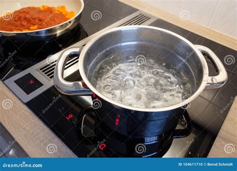 Boiling Water In A Cooking Pot An A Pan On A Stove Stock Photo Image