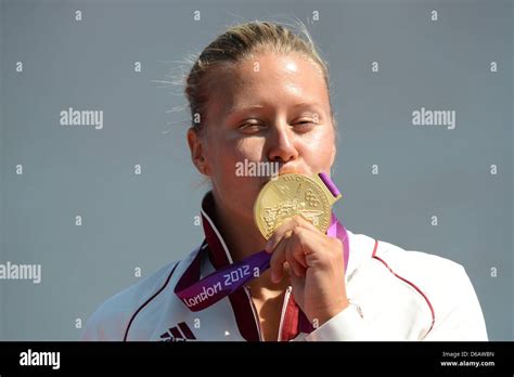 Hungarys Danuta Kozak Celebrates Gold On The Podium For The Kayak