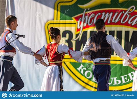 Young Men And Girls Dancing Serbian Traditional National