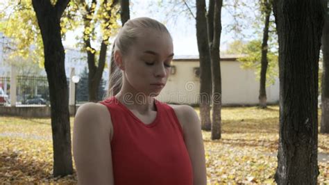 Fit Caucasian Busty Pretty Woman Walks Outdoors Along Ruined Statium