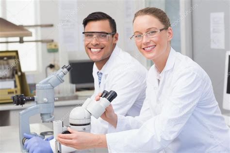 Happy scientists using microscope Royalty Free Stock Photos , #sponsored, #microscope, # ...