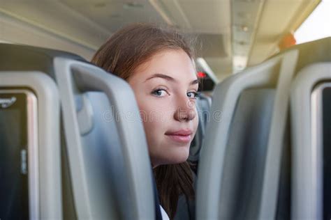 Teenager Girl Is In The Bus Travelling Sitting On The Seat Looking At