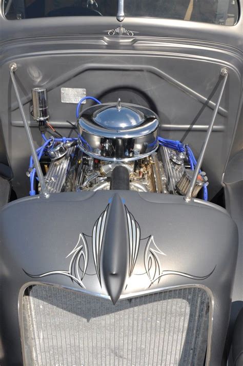 The Engine Compartment Of An Old Car With Chrome Paint And Silver Trims