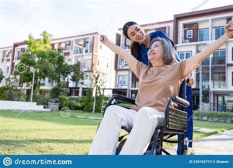 asian caregiver nurse support old disabled woman on wheelchair outdoor beautiful girl doctor