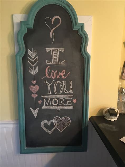 A Chalkboard With The Words I Love You More Written On It Next To A Counter