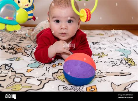 Cute Little Baby Boy During Tummy Time Looking At Camera 6 Months Old