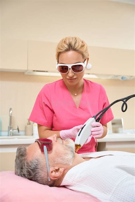 Professional Experienced Cosmetologist Doing Laser Hair Removal To Man