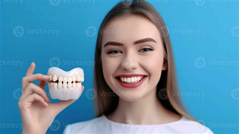 Young Woman With Beautiful Smile And Dentist Holding Educational Model