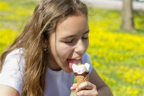 Beautiful Teen Girl Eating Ice Cream In A Waffle Cone In Summer Selective Focus Stock Photo