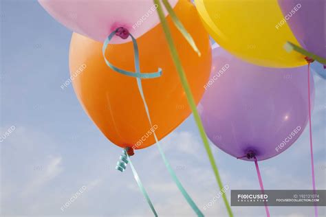 Bunch Of Colorful Balloons Floating In Air Against Blue Sky — Close Up