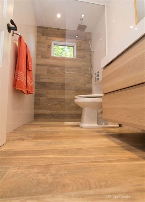 Designer kasey buick also included a few antique mirrors and traditional light fixtures to finish the look. Wood grained porcelain tiles bath to shower conversion ...