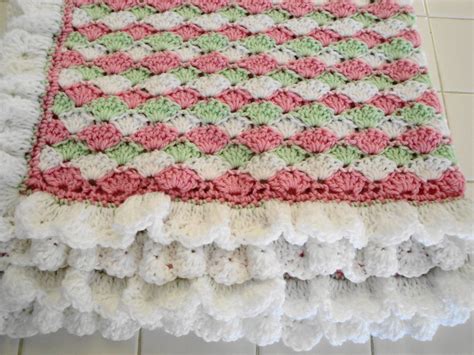 We found five shell stitch crochet blanket patterns that are fun to make and exciting to share with others, including pet shelters, and charities. Crocheted shell stitch baby blanket in pink green and ...