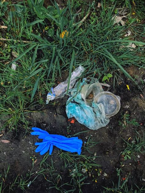 Disposable Medical Gloves On Ground With Single Use Plastic Trash How