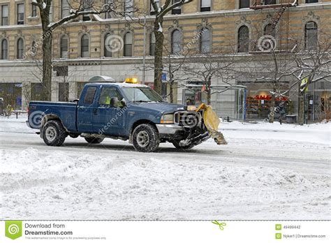 New york city became trapped under a deep snow. Truck With Plow Cleans Snow On The Street, New York City ...