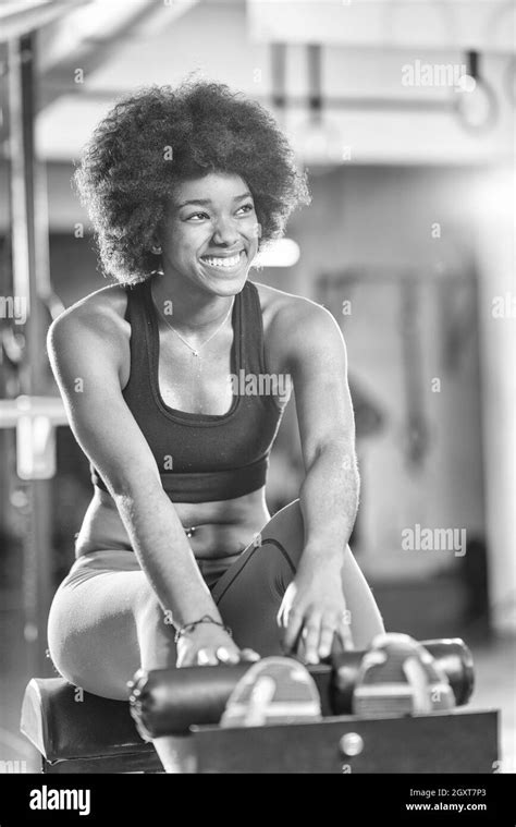 Young Fit African American Woman Doing Sit Ups In Fitness Studio At The