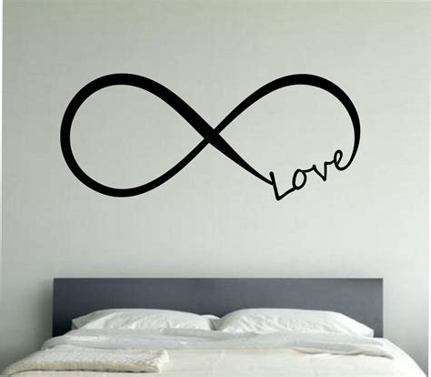 An Image Of A Bed With A Wall Decal That Says Love In The Middle