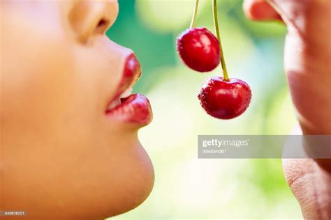 Woman Eating Cherries Closeup Photo Getty Images