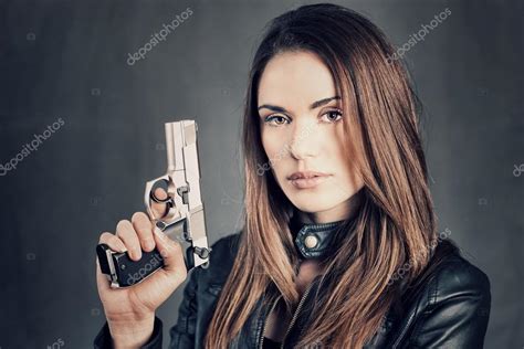 Woman Holding Up Her Gun — Stock Photo © Vwalakte 22331635