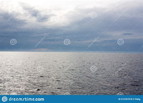 Blue Sea Or Ocean Water Surface Underwater With Sunny And Cloudy Sky